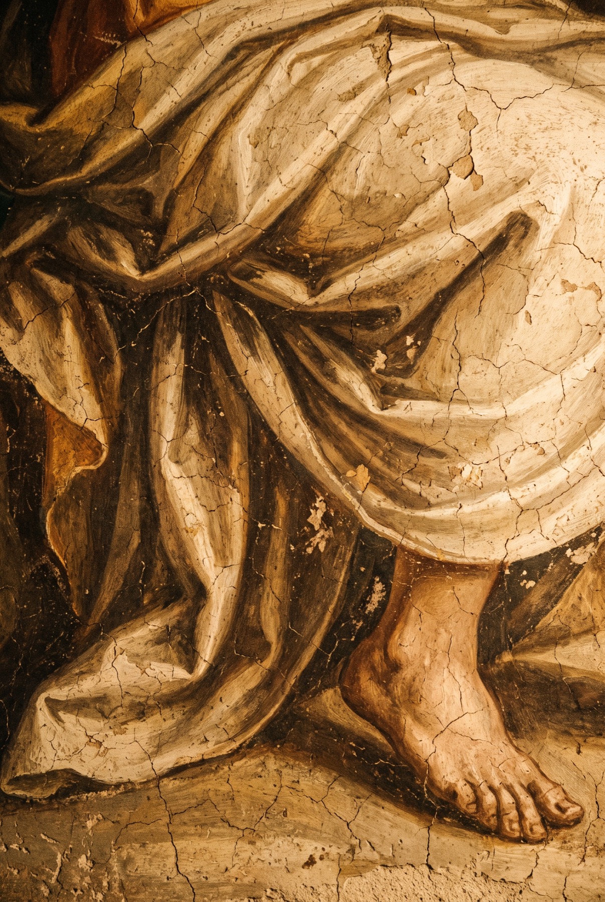 Weathered fresco, drapery and a bare foot